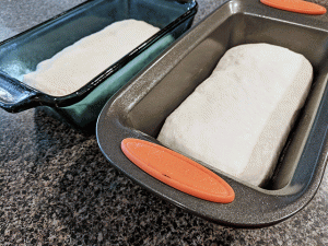 cottage bread dough divided into bread pans