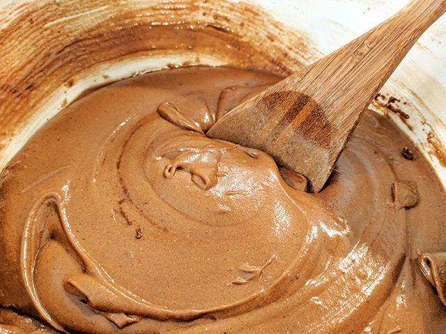 chocolate bread batter in bowl with mixing spoon to make Chocolate Bread With Marshmallow Glaze