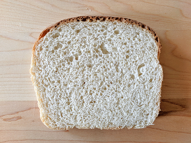 Single slice of cottage bread on cutting board