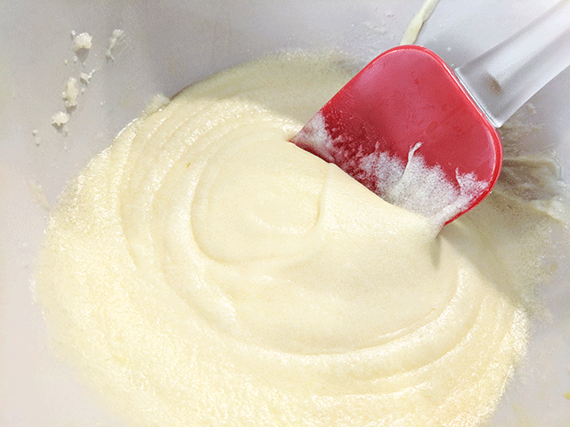 butter and sugar and eggs creamed together in bowl with spatula