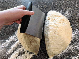 dough being cut with dough cutter