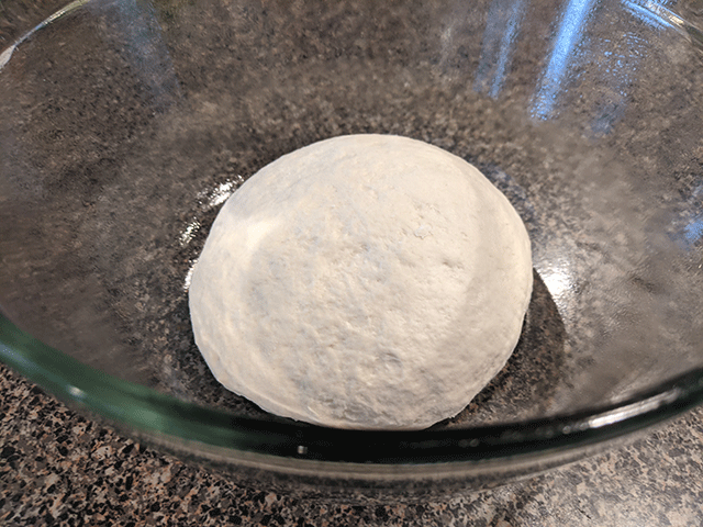 ball of sourdough discard bread dough in glass bowl