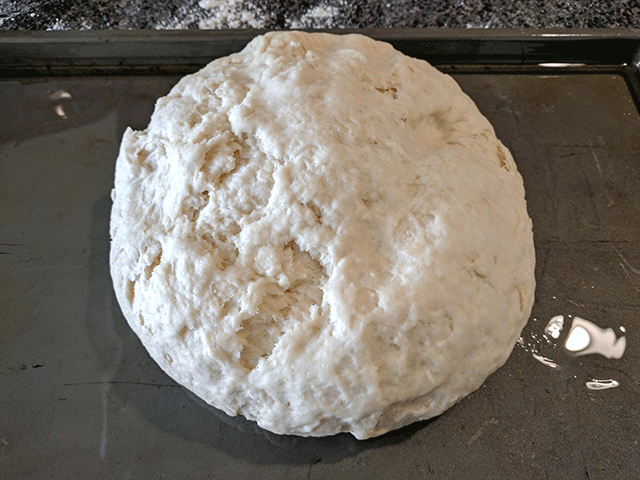 ball of focaccia dough on pan