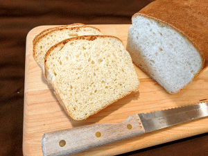 Crusty Sourdough cottage bread sliced on a cutting board