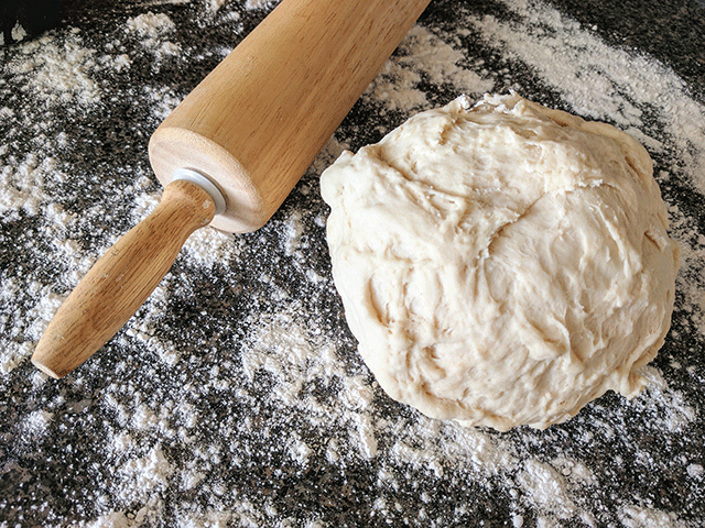 french bread dough ball and rolling pin