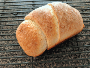mini loaf of cinnamon swirl bread on cooling rack