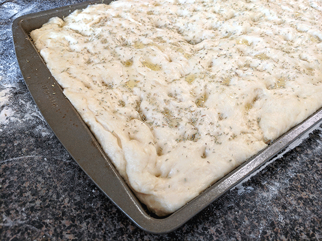 Focaccia dough rising in pan