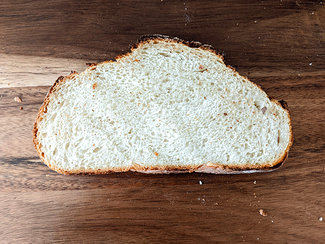 Single slice of sourdough discard bread on cutting board