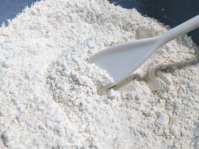 Flour in a bowl with spoon
