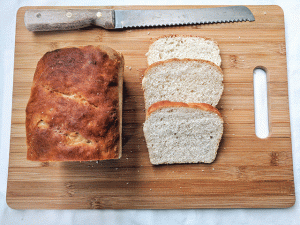 sourdough bread on cutting board with knife