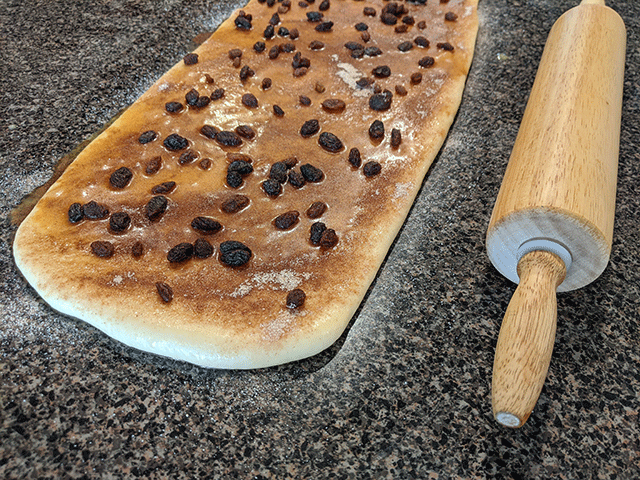 cinnamon raisin sourdough bread with filling next to rolling pin