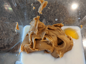 peanut butter milk and eggs in blender
