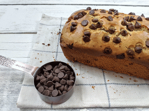 finished peanut butter chocolate chip bread on tea towel with chocolate chips