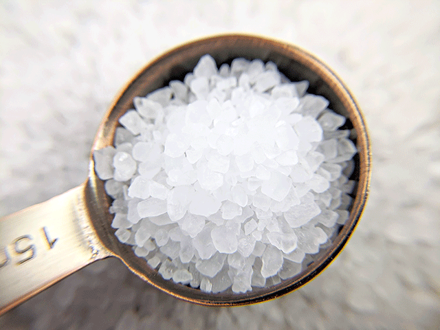 macro shot of sea salt in a spoon