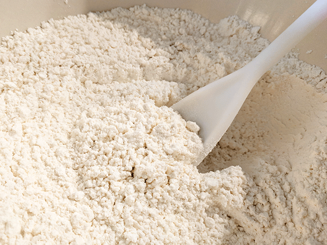 flour in a bowl with a spoon