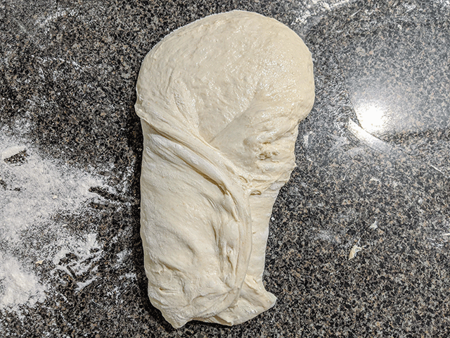 shaping sourdough on counter