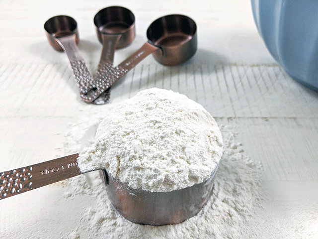 measuring cups with flour and blue bowl for 5 Beginning Bread Baking Mistakes and How to Avoid Them