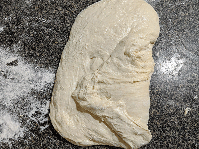 shaping sourdough on counter