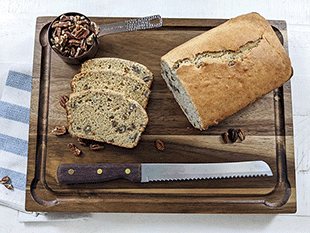 butter pecan bread on cutting board with bread knife