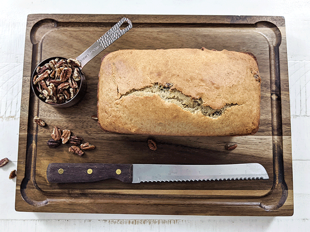 butter pecan bread on cutting board next to bread knife