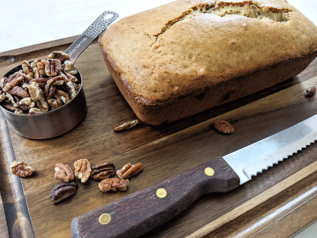 butter pecan bread on cutting board next to bread knife