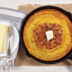 classic skillet cornbread in skillet with butter
