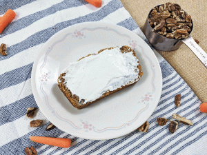 slice of carrot pecan bread with cream cheese frosting