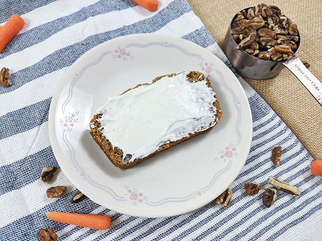 slice of carrot pecan bread with cream cheese frosting