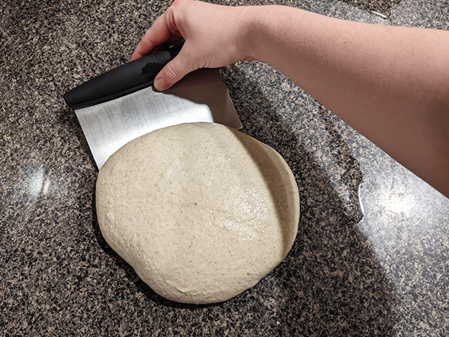 shaping dough with bench scraper