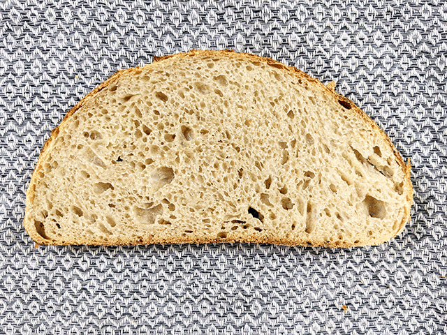 slice of white and wheat and rye artisan sourdough on tea towel
