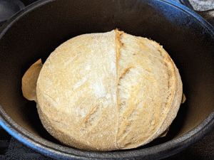 white and wheat and rye bread cooking in dutch oven