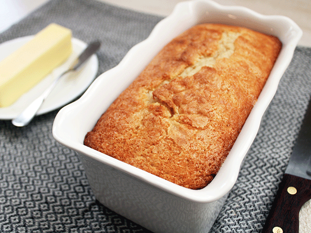 simple vanilla sweet bread in pan next to knife and butter