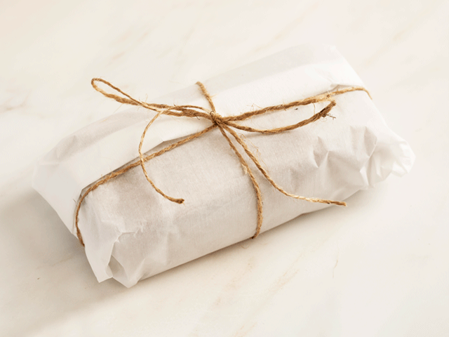 A loaf wrapped in parchment for How to Wrap Quick Bread for Gifting