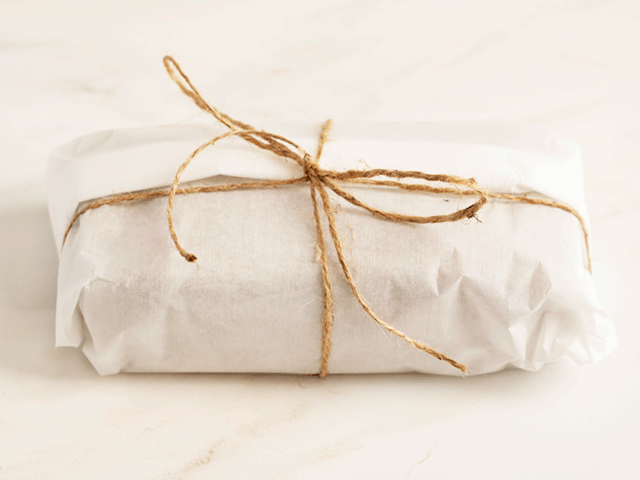 a loaf wrapped in parchment and twine for How to Wrap Quick Bread for Gifting