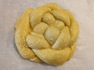 braided egg bread challah brushed with egg wash and sprinkled with sesame